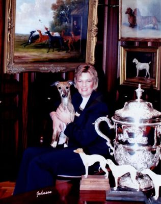 Lynn Yacoby-Wright, breeder of Cobyco Whippets, sits with a Whippet on her lap